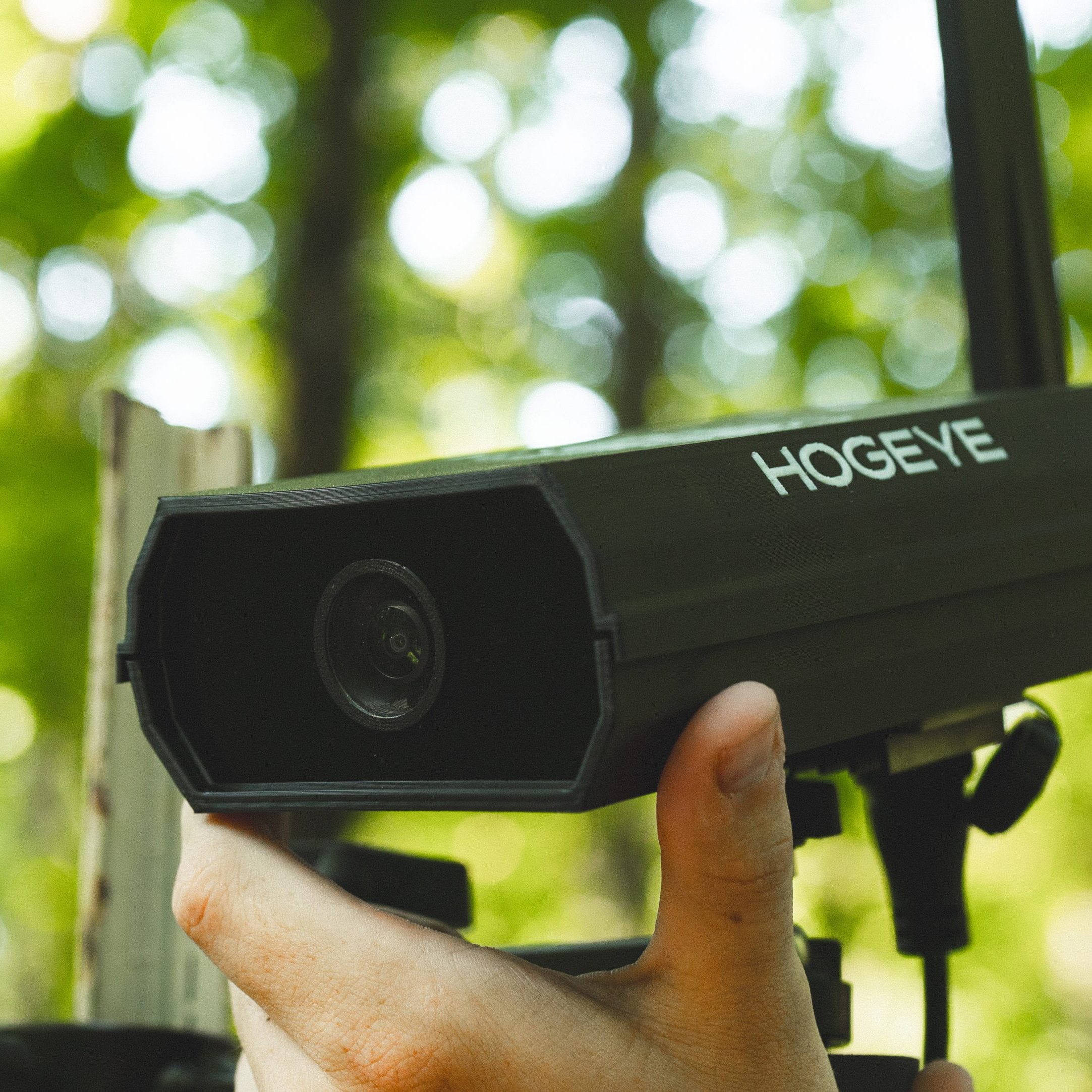 HogEye camera on a tripod in a wooded area