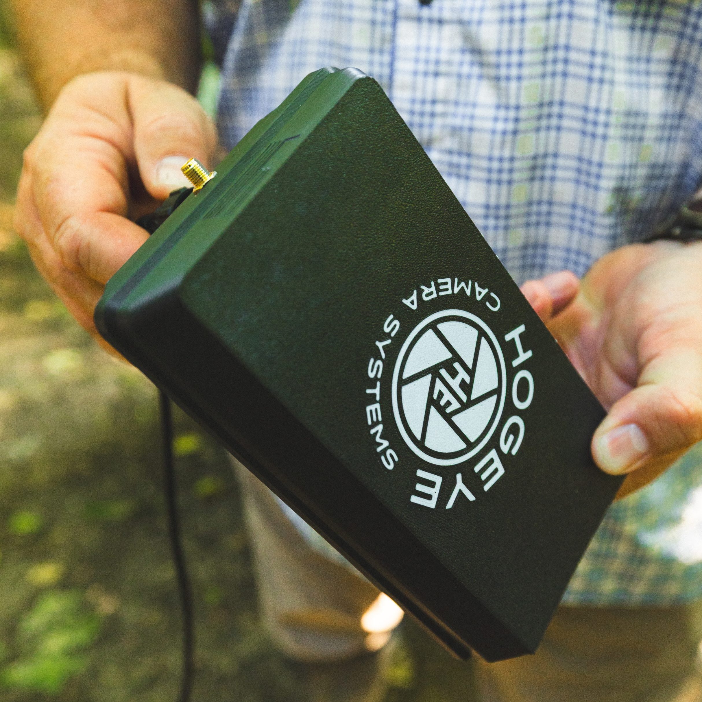 HogEye camera branding on a black device being held